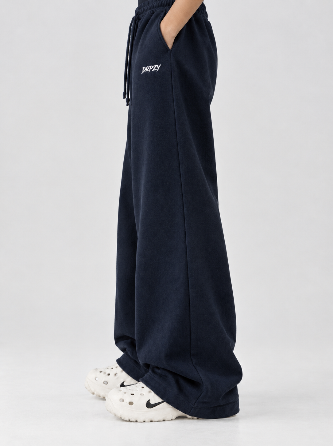 Drawstring waist and flat side pocket detail on the Dripzy navy relaxed trousers