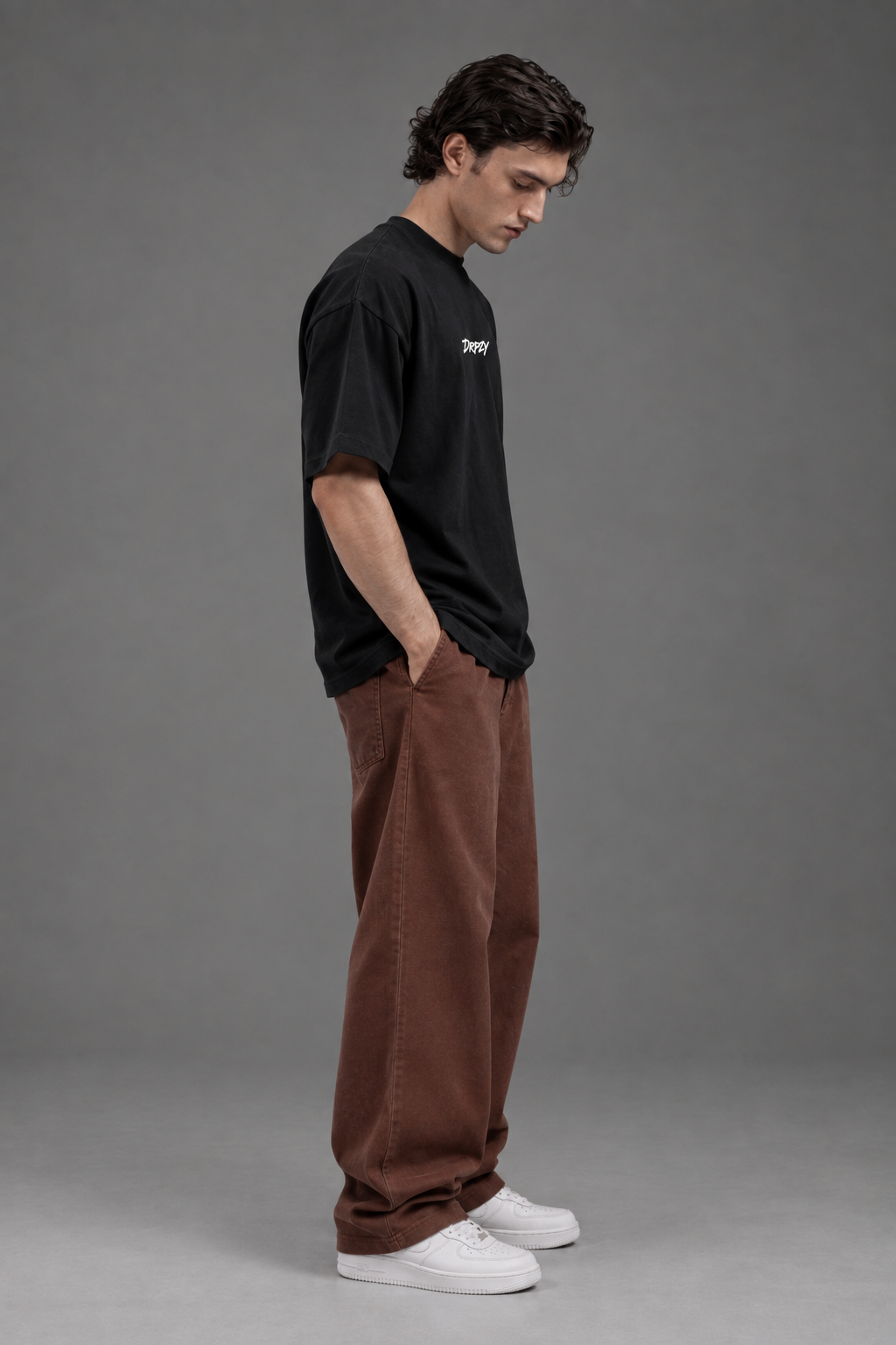 Relaxed drop-shoulder fit shown on the Dripzy plain black oversized tee
