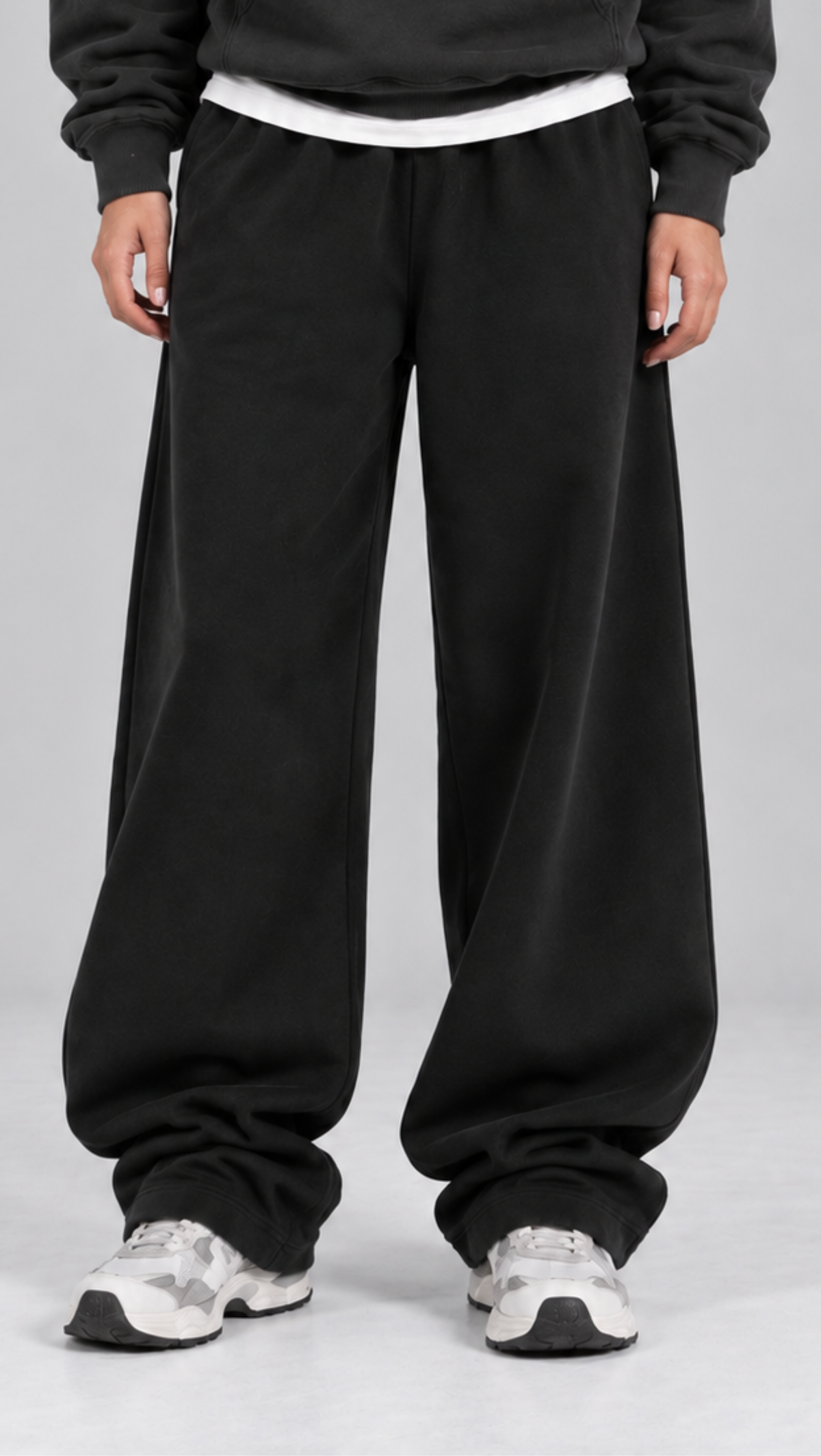 Side profile of the Dripzy black relaxed trousers showing the straight wide leg