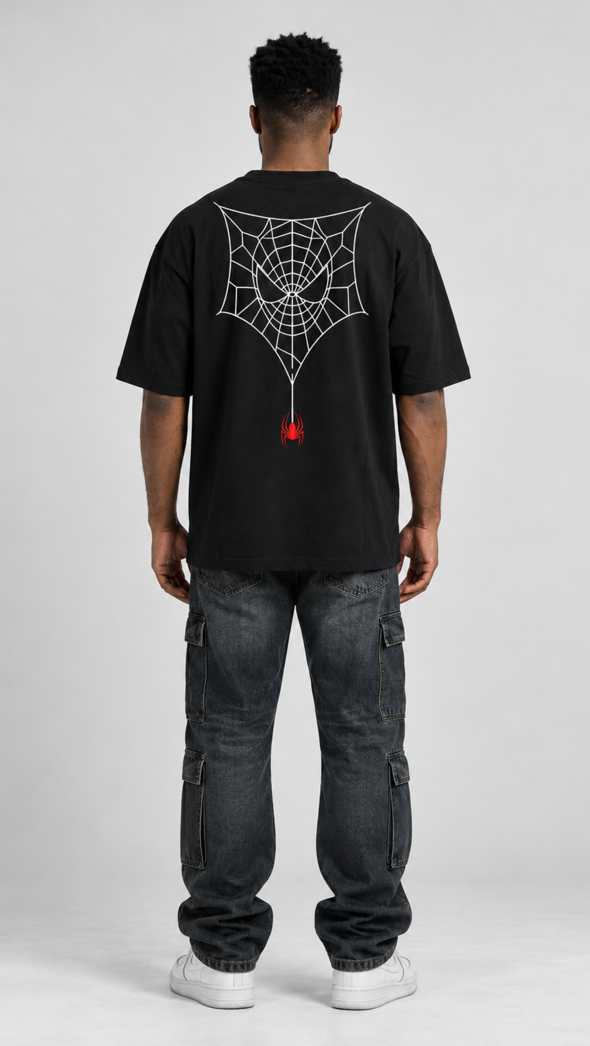 Spiderman print detail on the Dripzy black oversized cotton tee